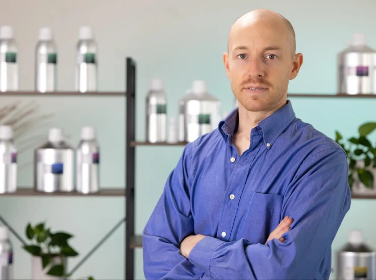 Robin Christiansen, founder of Loud Spectrum, standing in front of shelves of terpene bottles